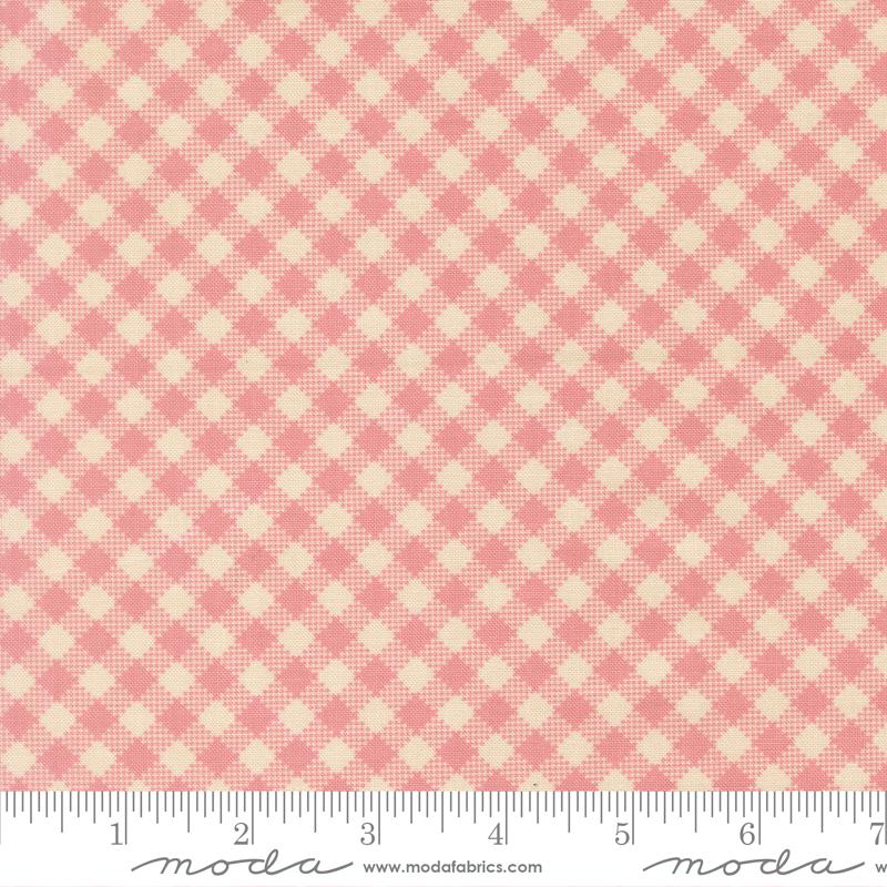 a fabric with a pink and beige checkered pattern.