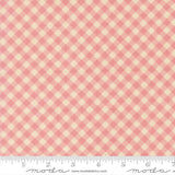 a fabric with a pink and beige checkered pattern.