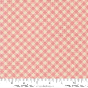 a fabric with a pink and beige checkered pattern.