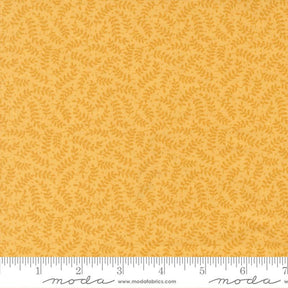 a fabric with a repeating pattern of yellow leaves on a yellow background.