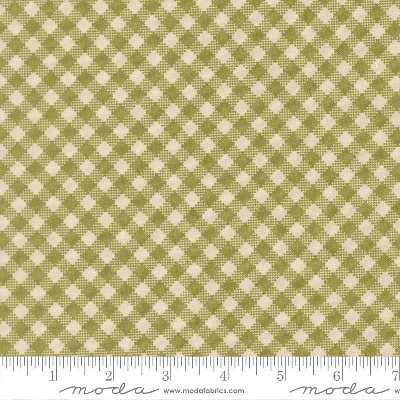 a fabric with a repeating pattern of green and beige squares, creating a checkered or plaid design.