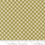 a fabric with a repeating pattern of green and beige squares, creating a checkered or plaid design.