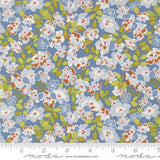 The image is a close-up of a fabric with a floral pattern in shades of blue, green, and white. The pattern consists of various flowers and leaves, creating a visually appealing and intricate design.