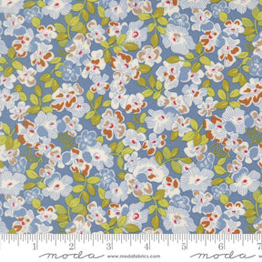 The image is a close-up of a fabric with a floral pattern in shades of blue, green, and white. The pattern consists of various flowers and leaves, creating a visually appealing and intricate design.