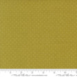 The image is a close-up of a fabric with a polka dot pattern, featuring a yellow background with white dots.