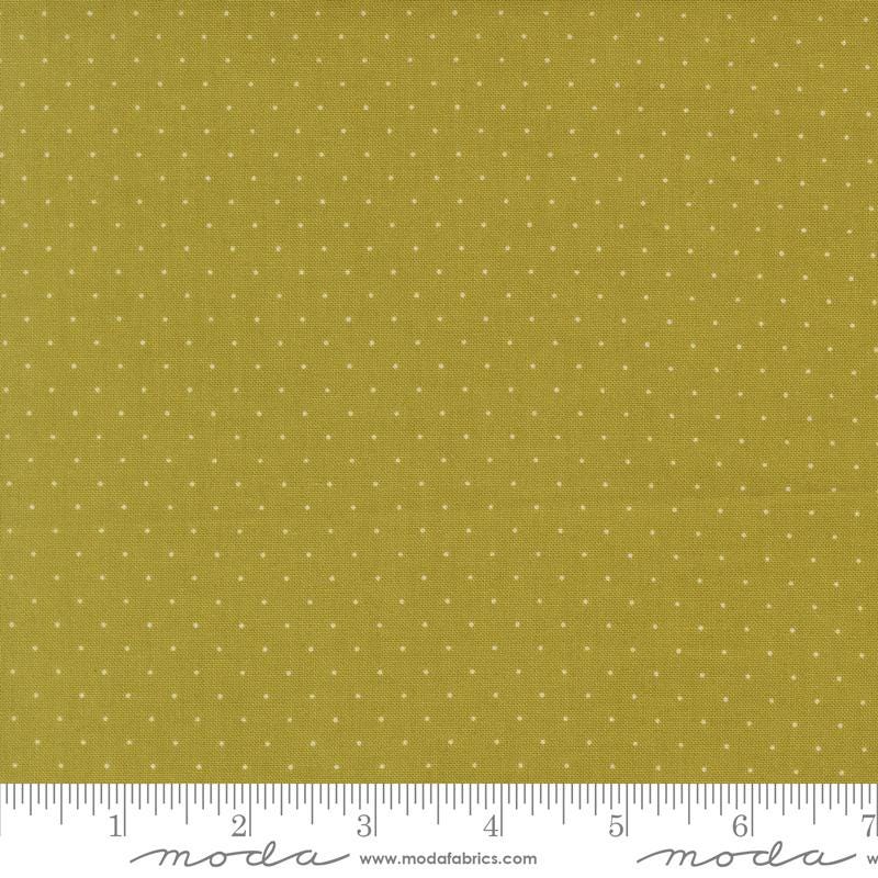 The image is a close-up of a fabric with a polka dot pattern, featuring a yellow background with white dots.
