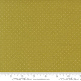 The image is a close-up of a fabric with a polka dot pattern, featuring a yellow background with white dots.