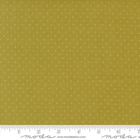 The image is a close-up of a fabric with a polka dot pattern, featuring a yellow background with white dots.
