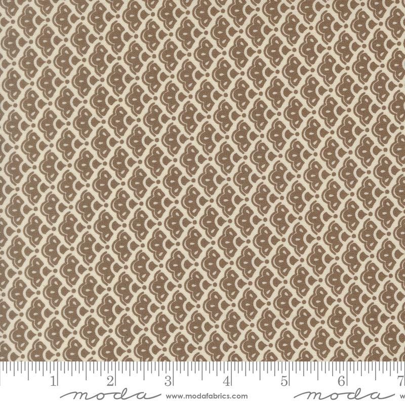 a repeating pattern of brown and beige flowers or leaves on a fabric surface.