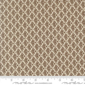 a repeating pattern of brown and beige flowers or leaves on a fabric surface.
