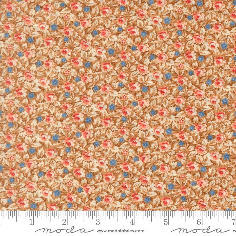 The image is a close-up of a fabric with a floral pattern in shades of brown and orange, with small blue flowers scattered throughout.