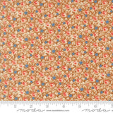 The image is a close-up of a fabric with a floral pattern in shades of brown and orange, with small blue flowers scattered throughout.
