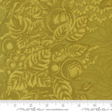 The image is a close-up of a fabric with a repeating pattern of leaves and flowers in a gold color.