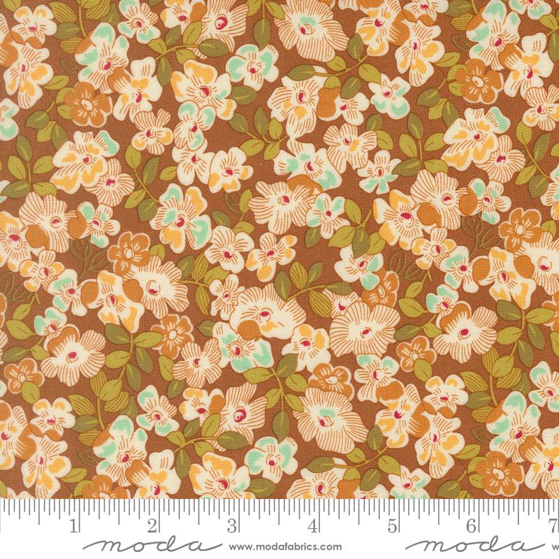 The image is a close-up of a fabric with a floral pattern, featuring a variety of flowers in shades of brown, orange, and green.