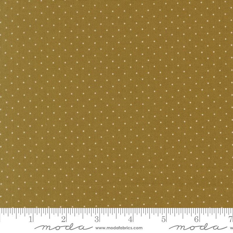 The image is a close-up of a fabric with a polka dot pattern, featuring a brown background with white polka dots.