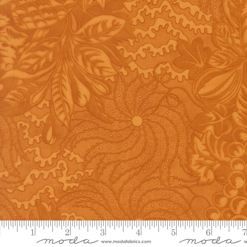 The image is a close-up of a fabric with a floral pattern in shades of orange and brown. The fabric appears to be made of Moda fabric, as indicated by the text in the image.