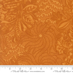 The image is a close-up of a fabric with a floral pattern in shades of orange and brown. The fabric appears to be made of Moda fabric, as indicated by the text in the image.