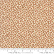 The image is a fabric with a repeating pattern of brown leaves or flowers on a cream-colored background.