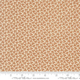 The image is a fabric with a repeating pattern of brown leaves or flowers on a cream-colored background.