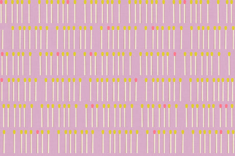 a repeating pattern of yellow and white matchsticks arranged in a grid-like fashion against a pink background.
