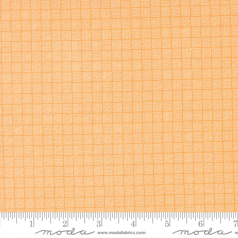 a close-up view of a fabric with a repeating pattern of orange and white squares, creating a textured and visually interesting design.