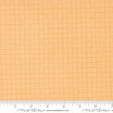 a close-up view of a fabric with a repeating pattern of orange and white squares, creating a textured and visually interesting design.