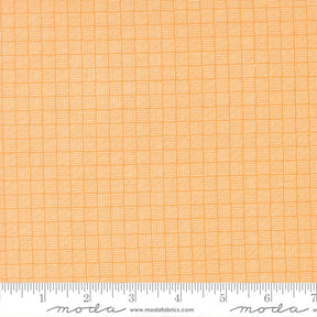 a close-up view of a fabric with a repeating pattern of orange and white squares, creating a textured and visually interesting design.