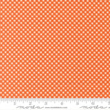 a repeating pattern of orange and white checkered squares on a fabric surface.