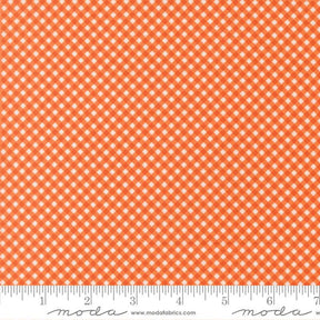 a repeating pattern of orange and white checkered squares on a fabric surface.