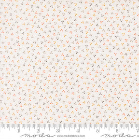 The image is a fabric with a small, multicolored dot pattern.