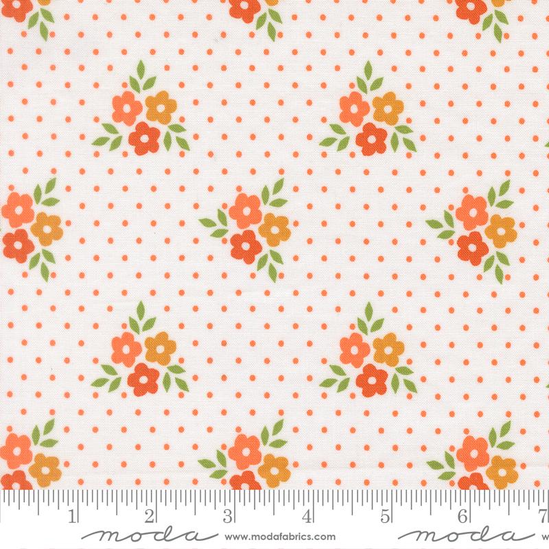 a fabric with a repeating pattern of orange flowers and green leaves against a white background with orange polka dots.