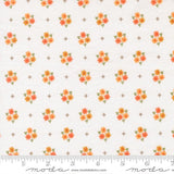 a repeating pattern of small orange flowers on a white background, with a ruler for scale at the bottom.