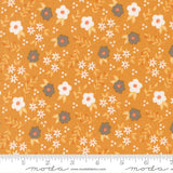 The image is a fabric with a repeating pattern of white and orange flowers and leaves on a yellow background.