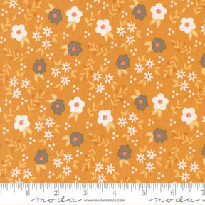 The image is a fabric with a repeating pattern of white and orange flowers and leaves on a yellow background.