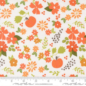 The image is a fabric with a repeating pattern of orange flowers and leaves, along with small orange pumpkins and dots. The pattern is spread across the fabric, creating a vibrant and colorful design.