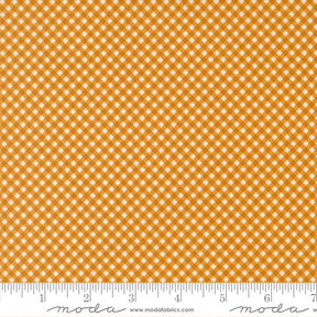 a close-up view of a fabric with a repeating pattern of small white squares arranged in a diagonal grid. The fabric appears to be made of a material with a checkered or gingham-like design.