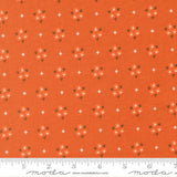 The image is a fabric with a repeating pattern of orange flowers and white stars on it. The pattern is evenly spaced and covers the entire fabric.