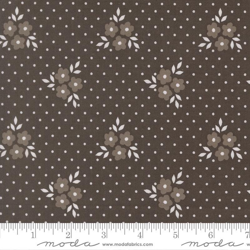 a fabric with a brown floral pattern and white polka dots.
