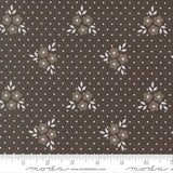 a fabric with a brown floral pattern and white polka dots.