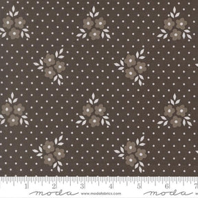 a fabric with a brown floral pattern and white polka dots.
