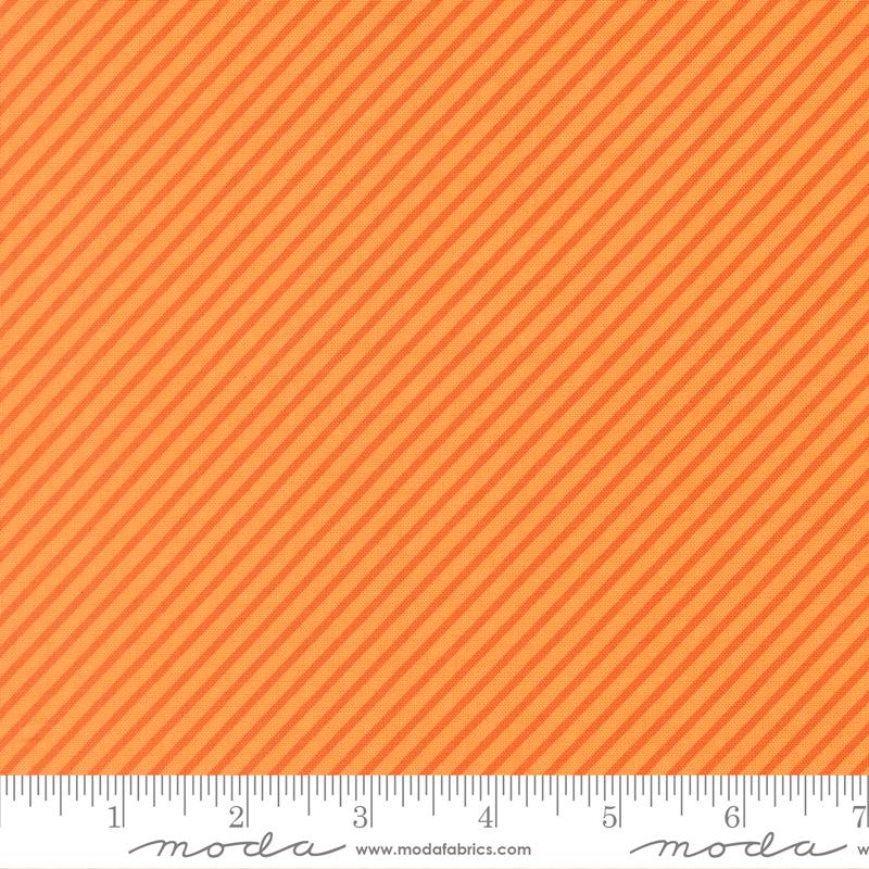 The image is a close-up of a fabric with a diagonal striped pattern in shades of orange and yellow.