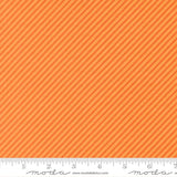 The image is a close-up of a fabric with a diagonal striped pattern in shades of orange and yellow.