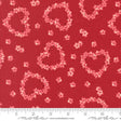 a red fabric with a pattern of pink hearts and flowers scattered across it.