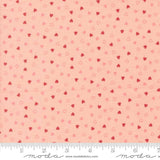 a fabric with a repeating pattern of small hearts in shades of pink and red. The pattern is spread across the fabric, creating a visually appealing and vibrant design.