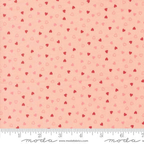 a fabric with a repeating pattern of small hearts in shades of pink and red. The pattern is spread across the fabric, creating a visually appealing and vibrant design.