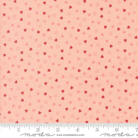a fabric with a repeating pattern of small hearts in shades of pink and red. The pattern is spread across the fabric, creating a visually appealing and vibrant design.