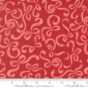 a red fabric with a repeating pattern of pink bows on it.