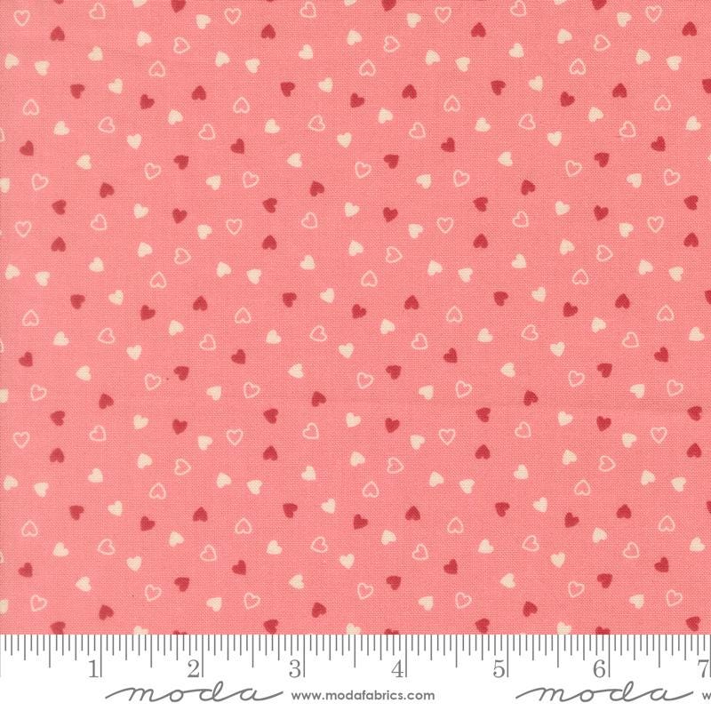 a fabric with a repeating pattern of small hearts in shades of pink and white. The pattern is spread across the fabric, creating a visually appealing and vibrant design.