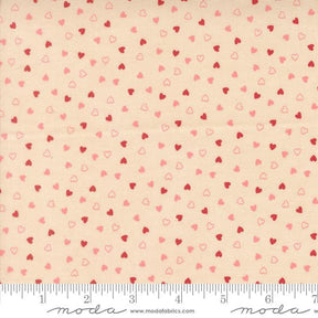 The image is a fabric with a repeating pattern of small hearts in shades of pink and red. The pattern is spread across the fabric, creating a visually appealing and textured design.