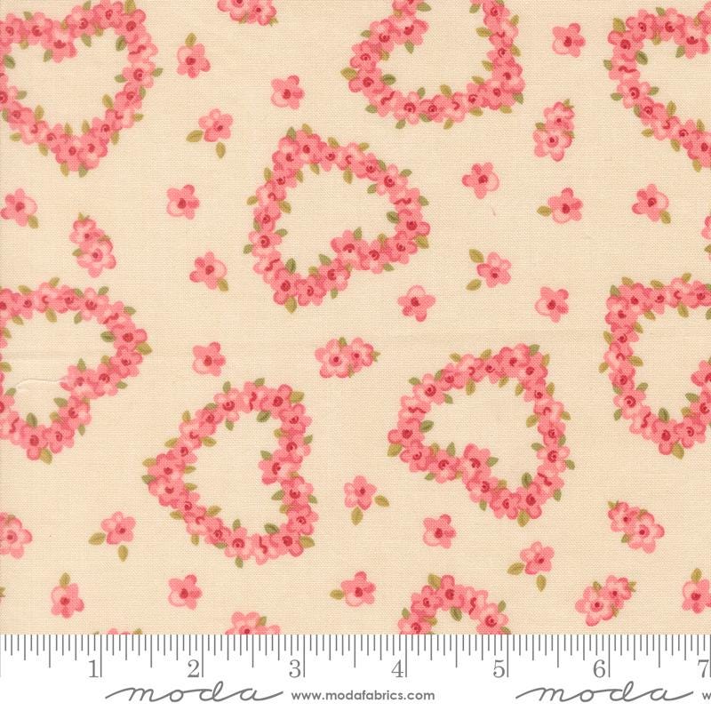 a fabric with a floral pattern of hearts and flowers on a light beige background.